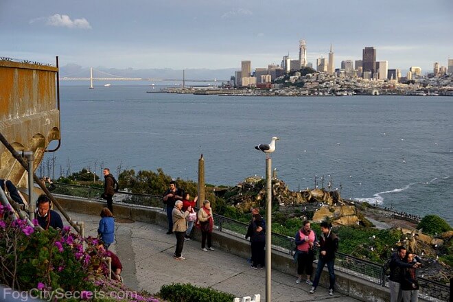 Night tour on Alcatraz, sunset view of city skyline.