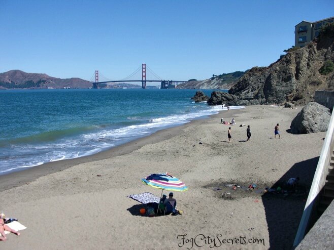 China Beach, sunbathers on beach and Golden Gate Bridge view. China Beach, sunbathers on beach and Golden Gate Bridge view.