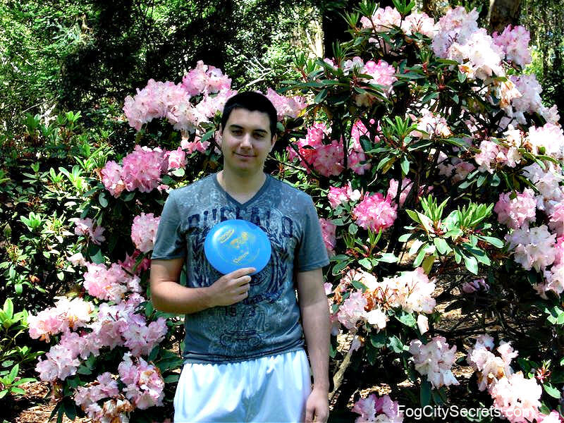 Man with blue disc at the SF disc golf course Man with blue disc at the SF disc golf course