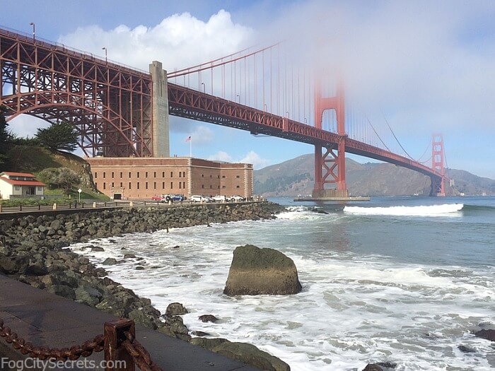 Fort Point sitting under the Golden Gate Bridge, with wisps of fog.