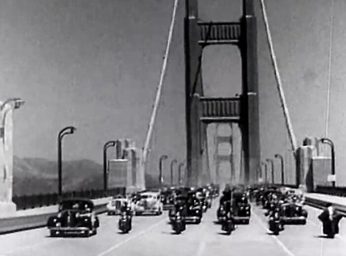 Car and motorcycle parade across the newly opened Golden Gate Bridge, 1937.
