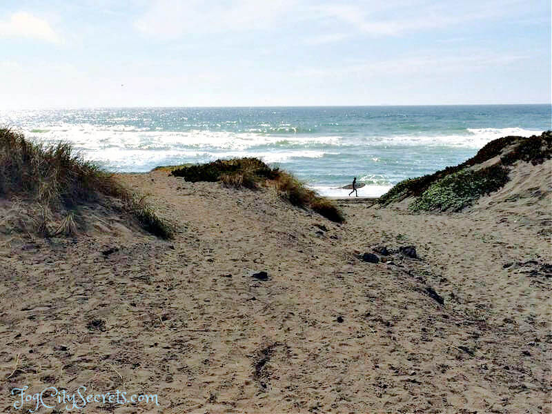 Surfer crossing dunes at Ocean Beach SF Surfer crossing dunes at Ocean Beach SF