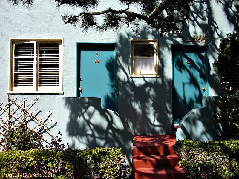 Outside of Ocean Park Motel rooms with turquoise doors