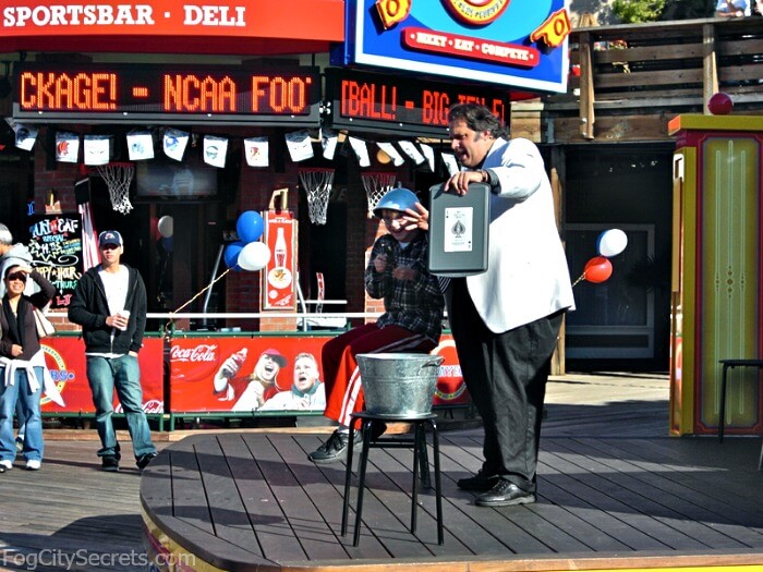 Magician performs on stage at Pier 39