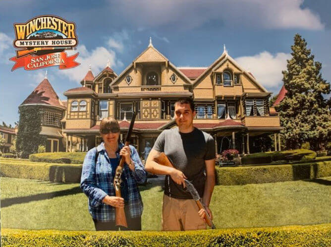 Posing with guns at the Winchester Mystery House