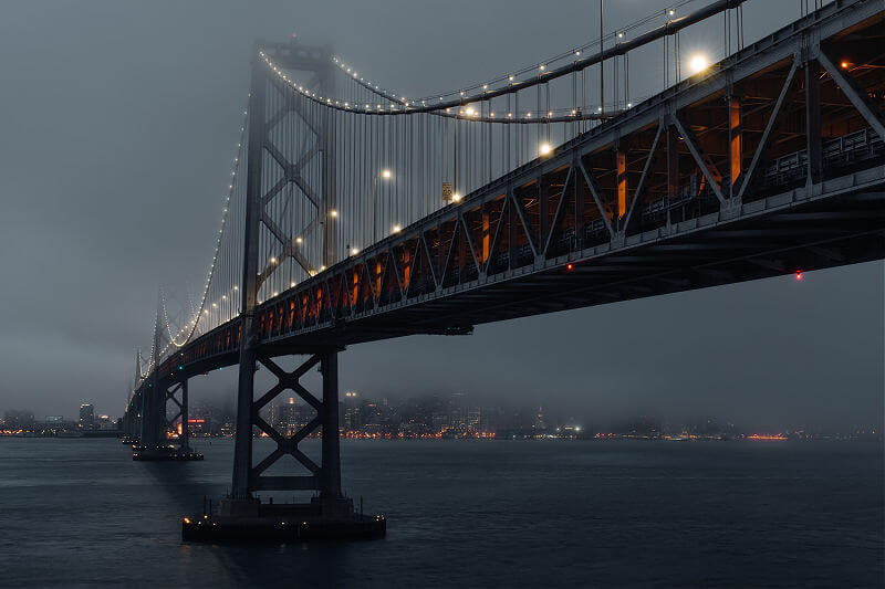 San Francisco Oakland Bay Bridge on foggy evening