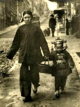 SF Chinatown mother and child carrying new years presents SF Chinatown mother and child carrying new years presents