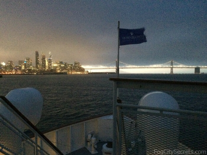 Night view of city skyline and Bay Bridge on San Francisco dinner cruise