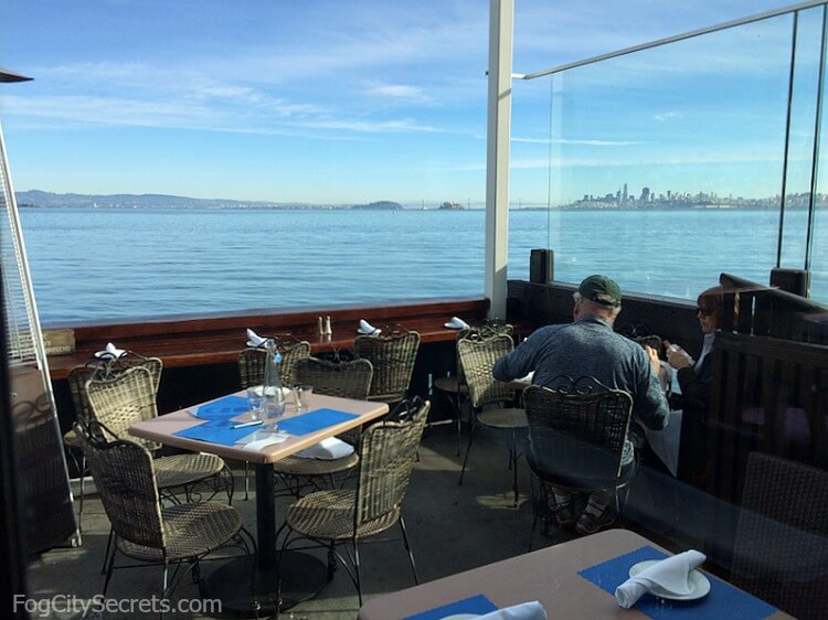 Outdoor seating at the Trident restaurant in Sausalito, view of city and bay.
