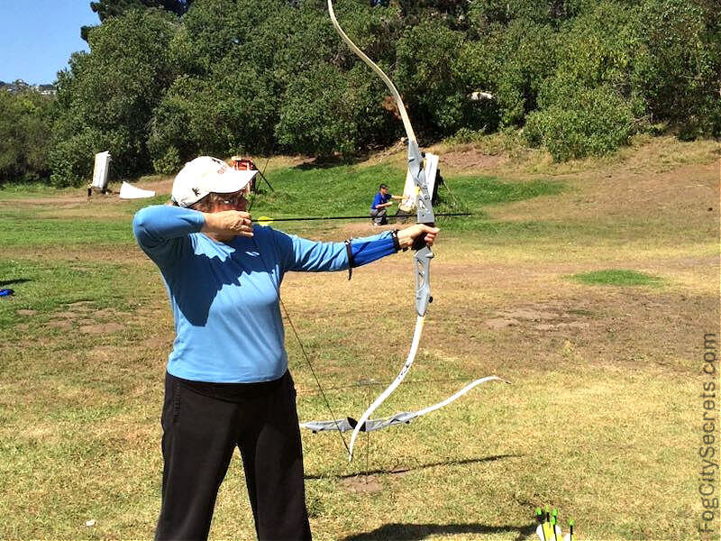 Woman shooting an arrow at a target Golden Gate Park Woman shooting an arrow at a target Golden Gate Park