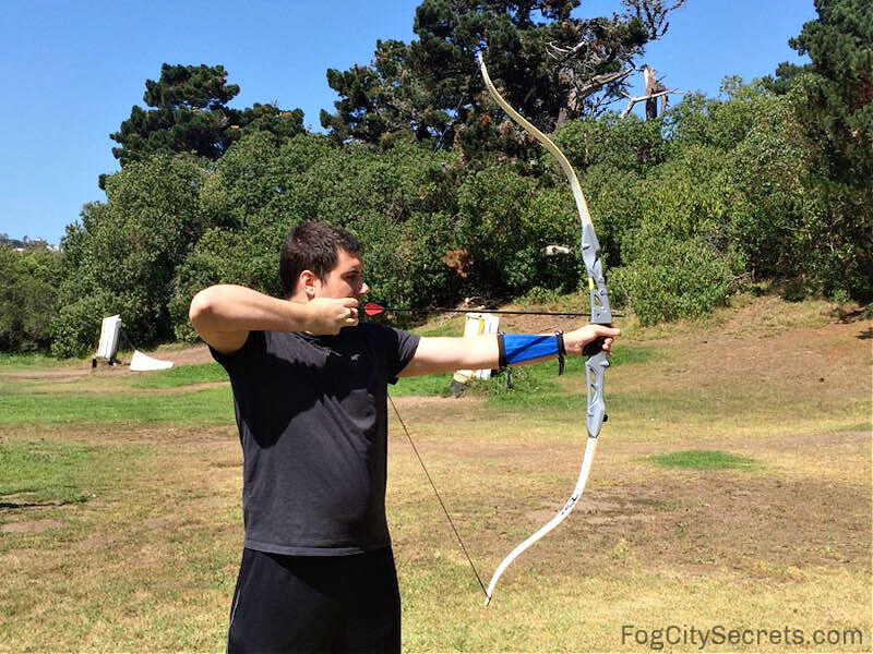 Man shooting an arrow with recursive bow Man shooting an arrow with recursive bow