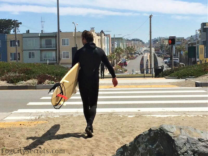 Surfer leaving Ocean Beach in SF Surfer leaving Ocean Beach in SF
